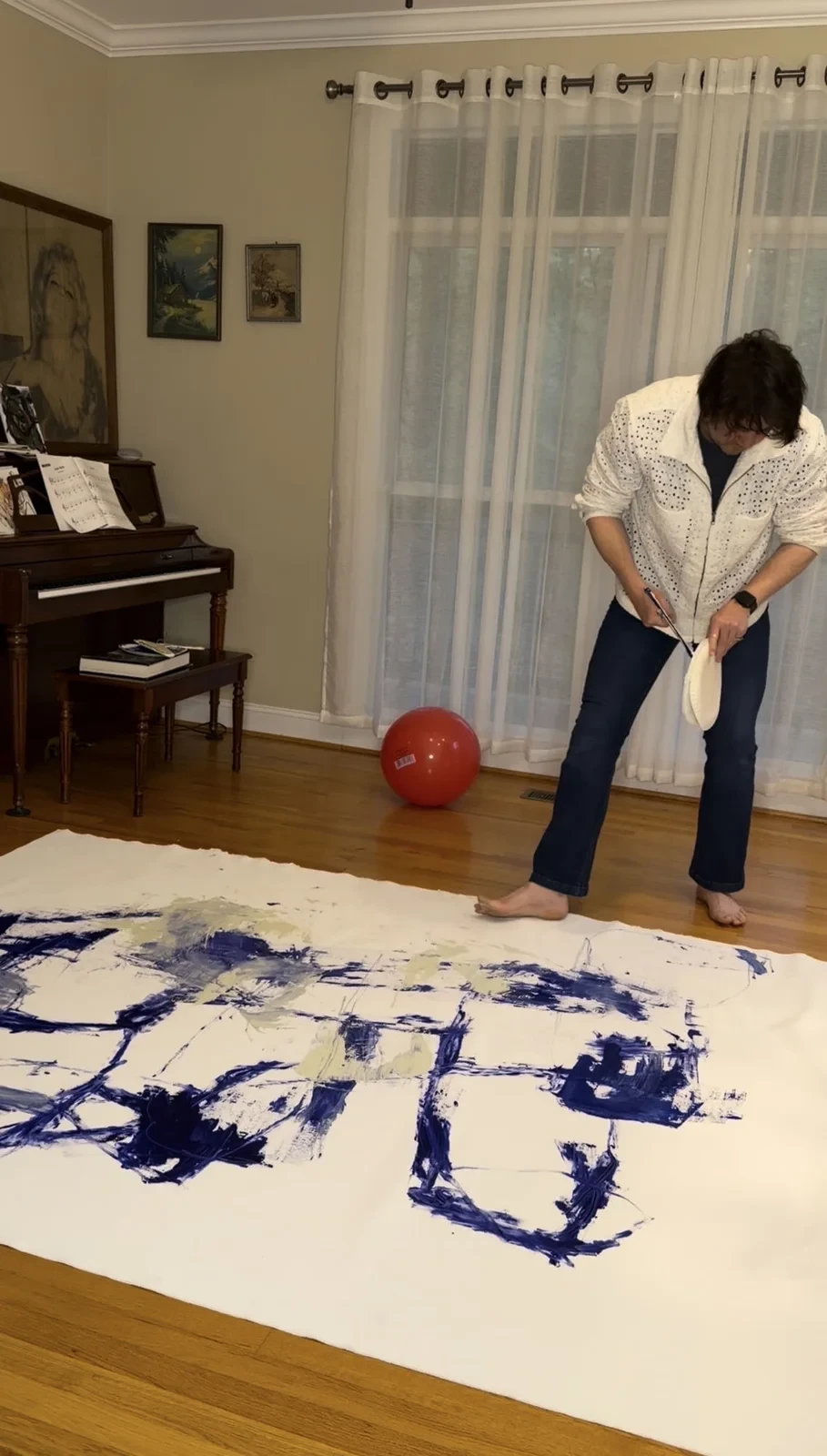 Miles Fink working on a large painting on the floor